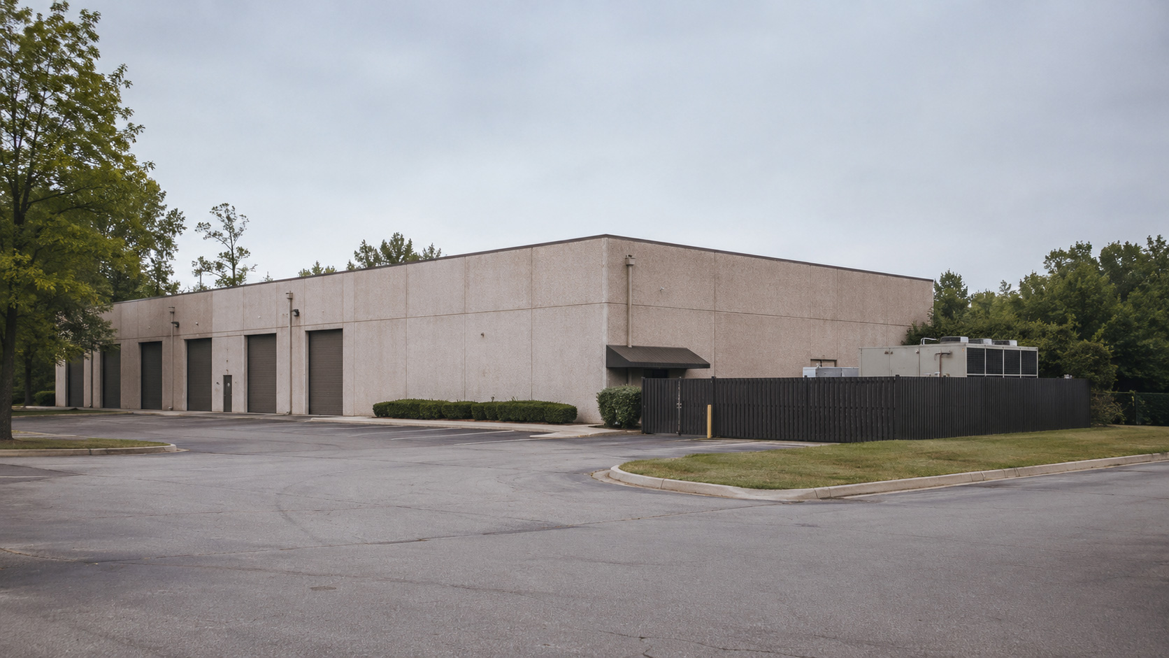 The existing concrete building at 1155 Powers Ferry Place
